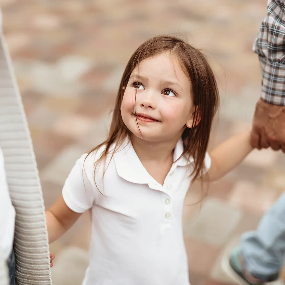 Child smiling up at mom at a Peace of Mind daycare.