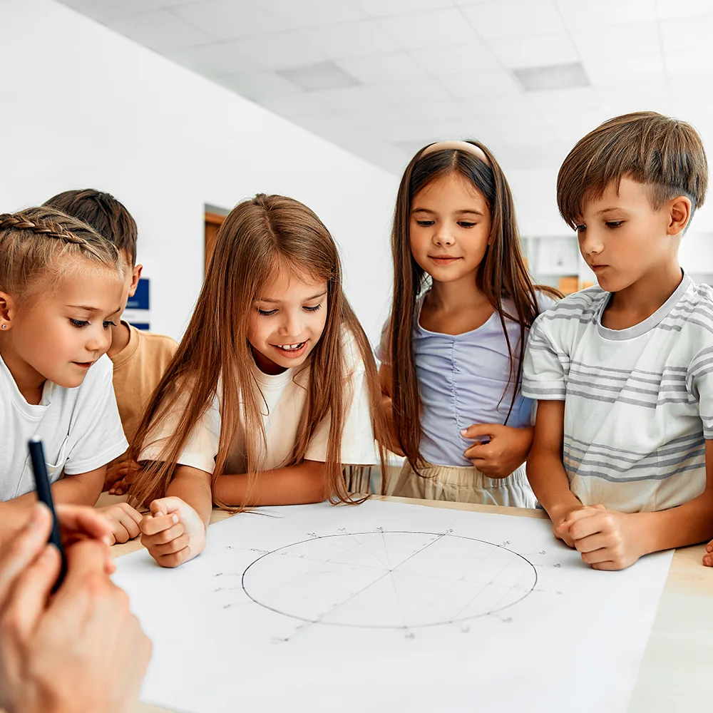 5 children standing around a drawing at a table at Peace of Mind daycare