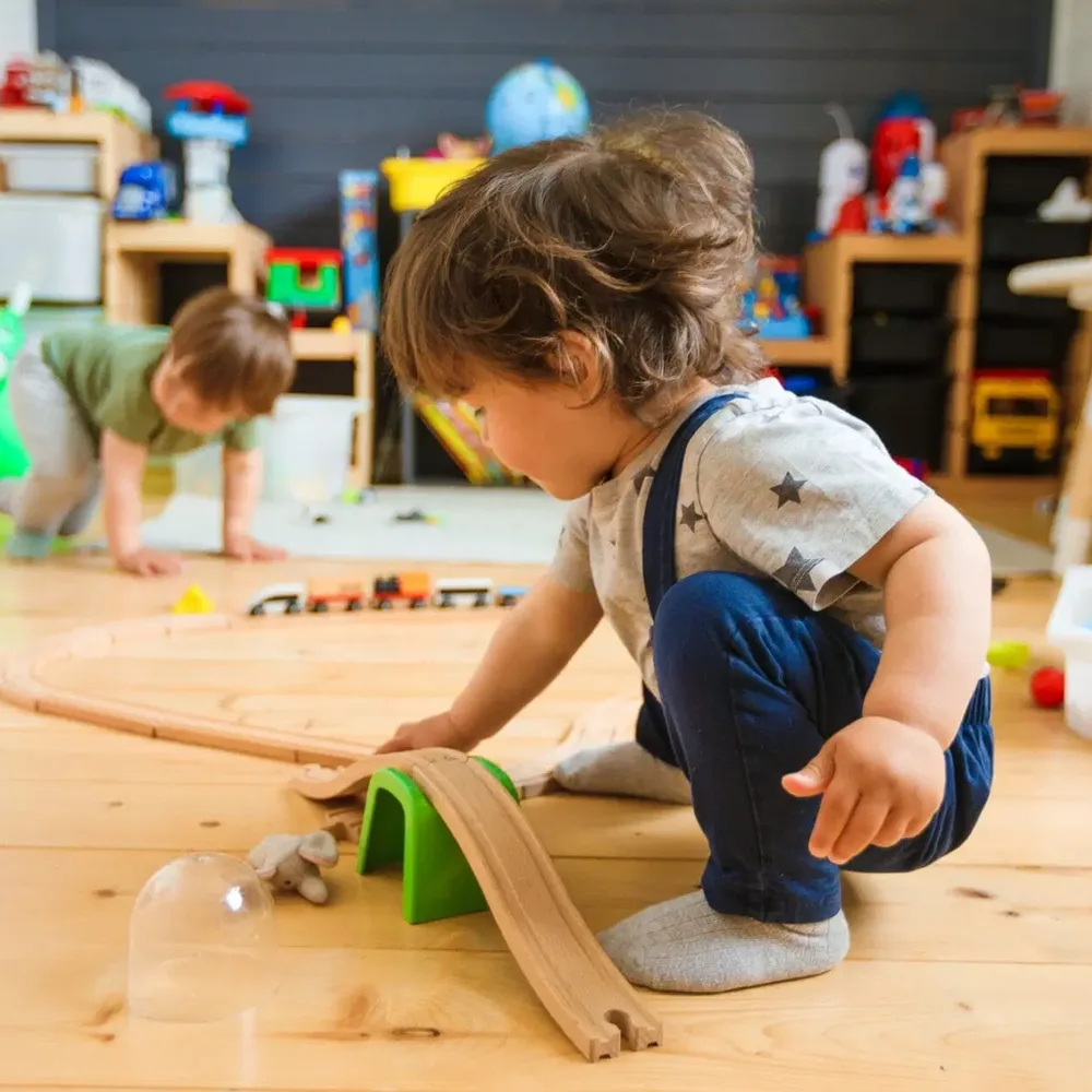 A child playing with a ramp at a Peace of Mind daycare