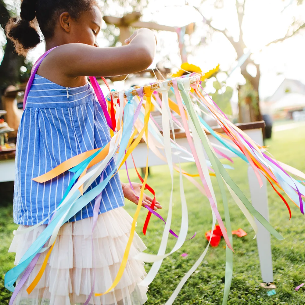 A child working on a colorful summer craft outside of a Peace of Mind daycare