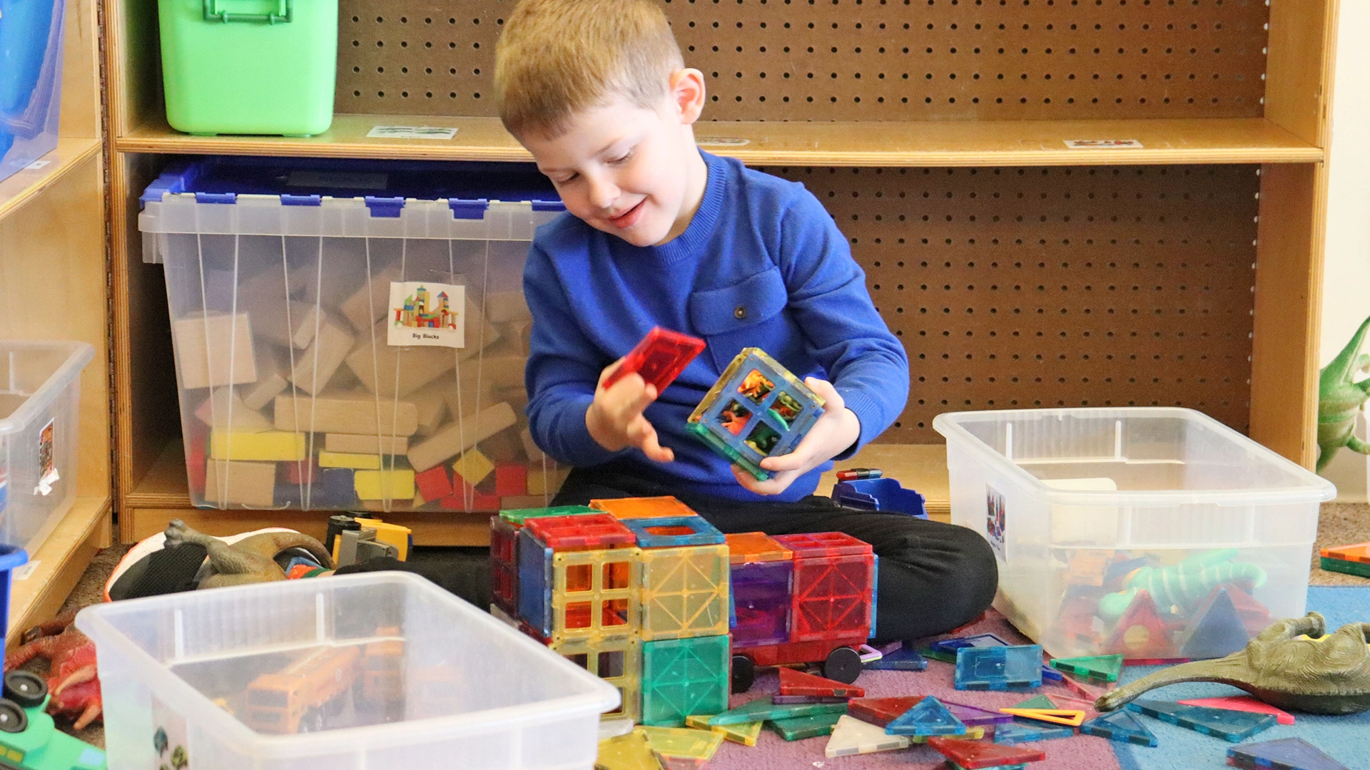 A child playing with building blocks at Peace of Mind