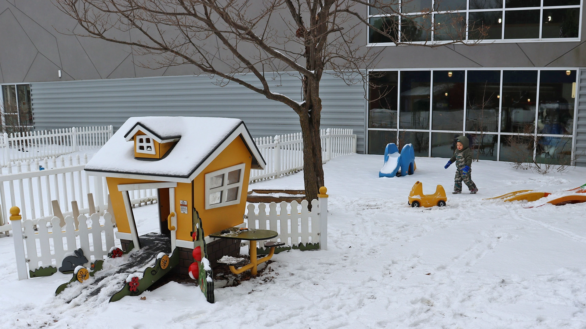 A play area and play house after a snowfall at Peace of Mind daycare
