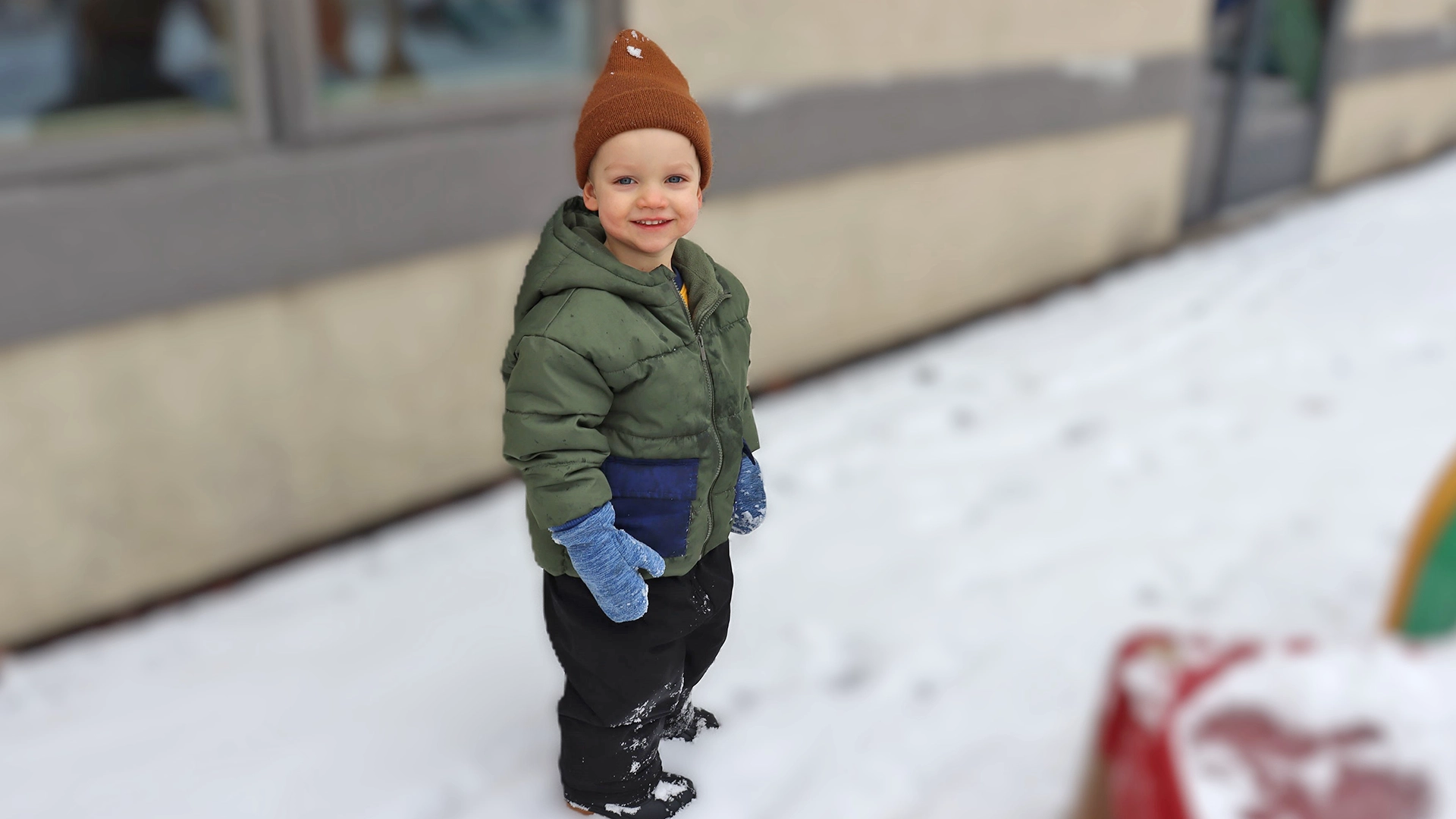 A bundled up child outside of Peace of Mind daycare