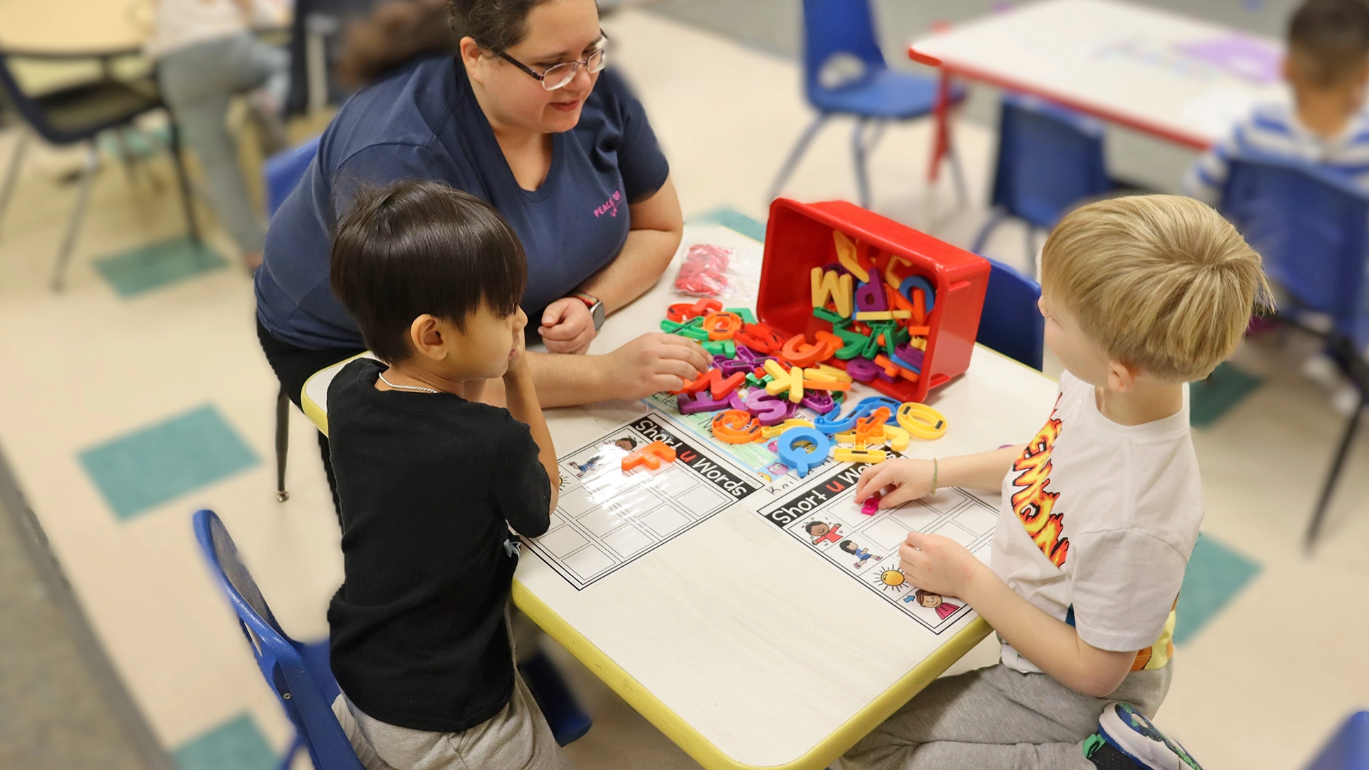 Children and a teacher playing with colorful blocks at Peace of Mind daycare