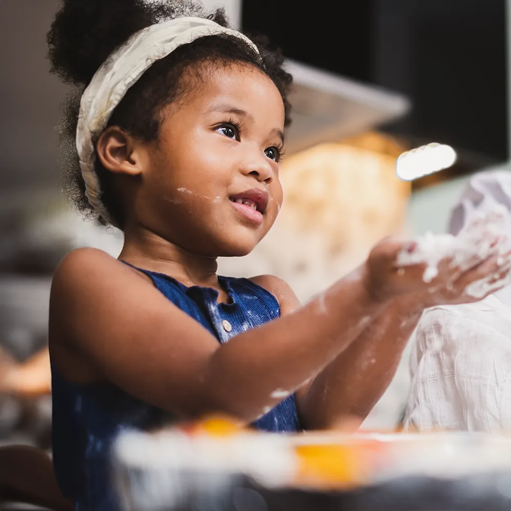Smiling child washing hands at a Peace of Mind daycare.