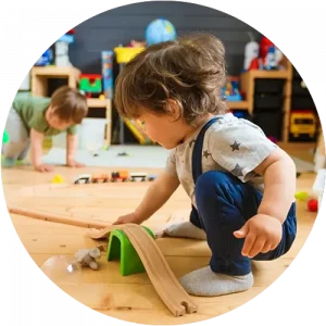 A child using a ramp toy to play at a Peace of Mind daycare